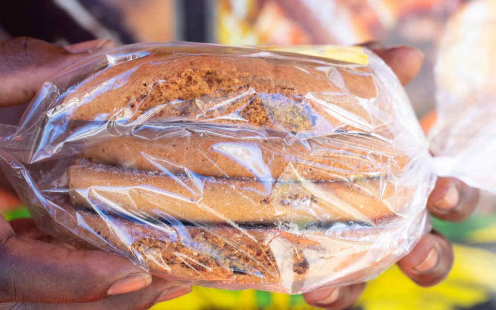 hands holding polythene bags on a roll used for packaging cookies