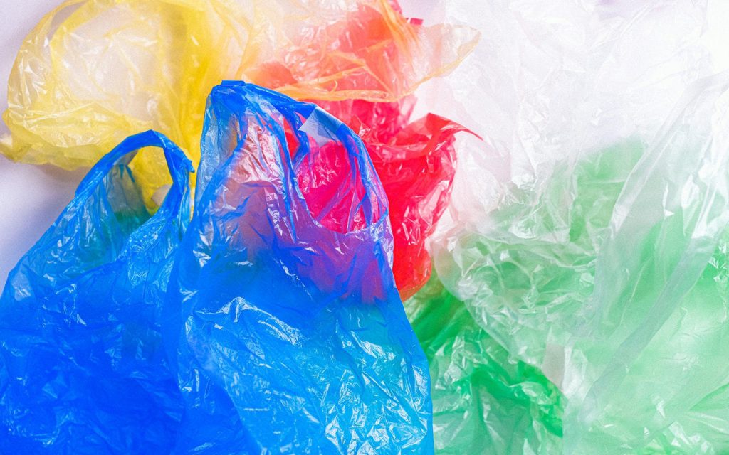 Polythene bags – clear as well as blue, red, green and yellow tints, on a white background