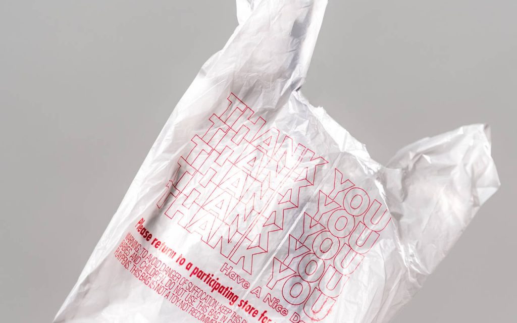 White coloured polythene bag with thank you printed on in red