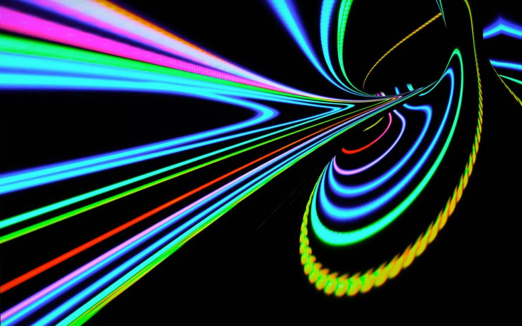 Abstract image of neon lights in rainow colours on a black background. Looks almost like an image from the LHC – or a physics experiment.