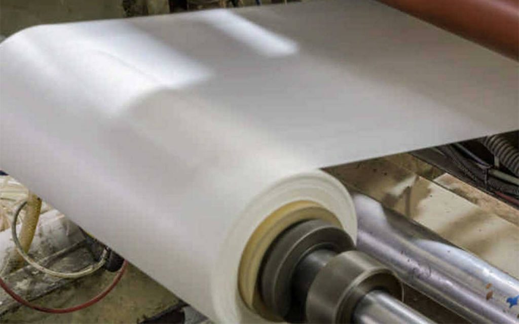 Printed lay flat tubing, being rolled through a packaging machine
