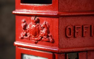 Extreme closeup of a red postbox in daylight