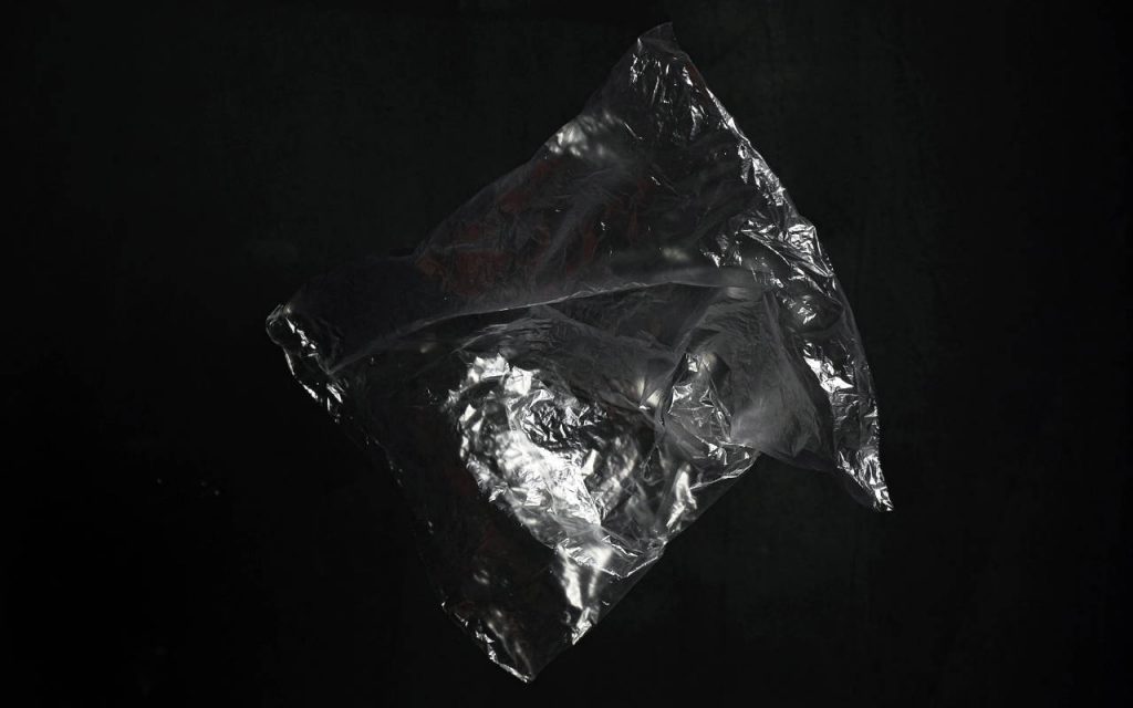 Photograph of a polythene bag on a black background. It appears to be a clear bottom weld polythene bag.